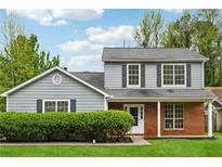 Charming two-story home featuring a well-maintained lawn and traditional architectural details at 5615 Crystal Hl, Stone Mountain, GA 30088