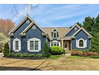 Charming two-story home boasts a well-manicured front yard, stone accents and a welcoming front porch at 2305 Stonevalley Ct, Cumming, GA 30041