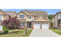 Charming two-story home with brick accents, a well-manicured lawn, and a two-car garage at 5480 Beaver Ridge Drive Dr, Cumming, GA 30040