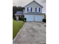 Charming two-story home featuring a two car garage and well-maintained landscaping at 5620 Tunbridge Wells Ct., Lithonia, GA 30058