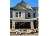 Two story brick home showing brickwork with uncovered windows and a two-car garage under construction at 3104 Marbella Cir # 2, Kennesaw, GA 30152