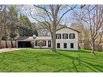 Charming two-story home with a well-maintained lawn, black shutters and mature trees at 2491 Falcon Ridge Dr, Grayson, GA 30017
