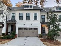 Charming townhome with two-car garage, well maintained landscaping and neutral paint at 407 Johnson Ct, Alpharetta, GA 30009