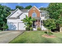 Charming two-story home featuring brick and white siding, a well-manicured lawn, and a two-car garage at 4551-0 Howell Farms Nw Rd, Acworth, GA 30101