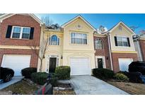 Charming townhome featuring well-maintained landscaping, a two-car garage, and welcoming front entrances at 4134 Rogers Creek Ct # 41, Duluth, GA 30096