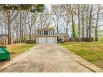 Charming two-story home featuring a two-car garage and a landscaped front yard at 5175 Walker Rd, Stone Mountain, GA 30088