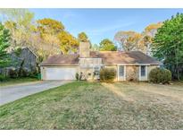 Charming single-story home featuring a stone accent wall and an attached two-car garage at 870 Chapman Cir, Stone Mountain, GA 30088
