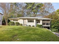 Charming, updated single-story home featuring a lush front yard and inviting curb appeal at 2506 Parkdale Ne Pl, Atlanta, GA 30305