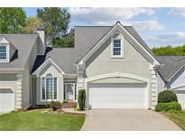 Charming home featuring a two-car garage, well-manicured lawn, and tasteful landscaping at 1244 Newbridge Ne Trce, Atlanta, GA 30319