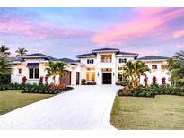 Elegant white home featuring lush landscaping, a circular driveway, and a welcoming two-story entrance at 0 Ebenezer Rd, Fayetteville, GA 30215