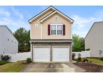 Charming home with a two-car garage, stone accents, and neutral siding on a bright day at 112 Silver Fox Trl, Dallas, GA 30157