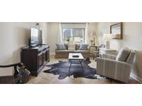Cozy living room featuring a comfortable sofa, accent chair, and decorative rug at 2285 Peachtree Ne Rd # 1207, Atlanta, GA 30309