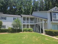 Inviting condominium complex featuring covered porches, landscaped grounds, and classic architectural details at 35 Rumson Se Ct, Smyrna, GA 30080