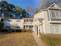 Inviting multi-level condominium with covered porch, gray siding, and well-maintained landscaping at 35 Rumson Se Ct, Smyrna, GA 30080