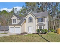 Charming two-story home with attached garage and well-maintained lawn at 498 Pecan Wood Cir, Fairburn, GA 30213