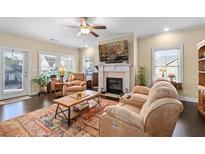 Comfortable living room featuring hardwood floors, fireplace, and cozy furniture at 57 Cedarcrest Village Ln, Acworth, GA 30101
