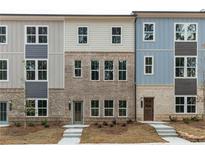Charming exterior view of newly built townhomes with varied color schemes and brick accents at 1162 Buice Lake Pkwy, Acworth, GA 30102