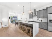 Modern kitchen with a large island, stainless steel appliances, and an open concept design to the living area at 699 Pryor Sw St # 4, Atlanta, GA 30315