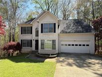 Two-story home featuring an attached garage, a well-maintained lawn, and a classic design at 802 Crow View Ct, Woodstock, GA 30189