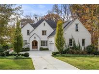 Stunning two-story brick home with a well-manicured lawn and inviting curb appeal at 803 Courtenay Ne Dr, Atlanta, GA 30306