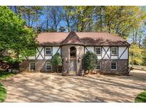Charming brick home with unique turret, trim accents, manicured landscaping, and a spacious driveway at 3186 Sugarplum Ne Rd, Atlanta, GA 30345