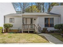 Charming single-story townhome featuring a wooden porch and well-maintained front lawn at 404 Willow Way, Villa Rica, GA 30180