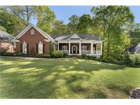 Charming single-story brick home with a welcoming front porch and manicured lawn at 3100 Templeton Ln, Loganville, GA 30052