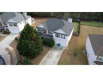 A beautiful two-story home in a suburban neighborhood featuring an attached two-car garage and driveway at 605 Oak Terrace Drive, Covington, GA 30016