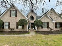 Charming brick home features a well-manicured lawn and mature landscaping for great curb appeal at 2814 Michelle Lee Dr, Dacula, GA 30019