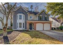 Charming two-story home with a well-manicured lawn and attached two-car garage at 4975 Skyland Pkwy, Cumming, GA 30028