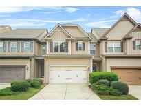 Charming two-story townhome with a well-manicured front yard and attached garage at 5669 Cobblestone Creek Pl # 12, Mableton, GA 30126