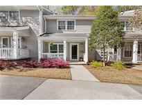 Charming townhome with a well-manicured front yard, covered porch, and neutral siding at 2794 Farmstead Se Rd, Smyrna, GA 30080