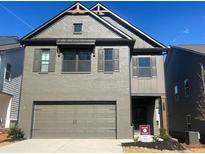 Beautiful two-story home with a two-car garage and classic architectural details at 4574 Eastbrook Pl, Snellville, GA 30039