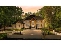The property features a stunning brick facade, lush landscaping, and a spacious driveway at 450 Birkdale Dr, Fayetteville, GA 30215