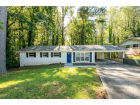 Charming single-story home featuring a covered carport, freshly painted exterior, and a well-manicured lawn at 4704 Apache Sw Trl, Atlanta, GA 30331