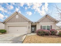 Charming single Gathering home featuring a two-car garage and landscaped front yard at 228 Dorothy Ln, Lawrenceville, GA 30046