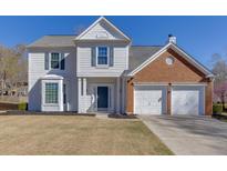 Charming two-story home featuring a combination of white siding and brick, plus an attached two-car garage at 230 Ascalon Ct, Johns Creek, GA 30005