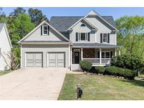 Charming home featuring manicured lawn, two-car garage, and inviting front porch at 55 Maple Leaf Ct, Dallas, GA 30157