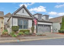 Charming home featuring a two-car garage, brick driveway and landscaped front yard at 630 Stickley Oak Way, Woodstock, GA 30189