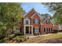 Beautiful two-story brick home with manicured landscaping and a welcoming front porch at 1170 Chasewood Trl, Alpharetta, GA 30005