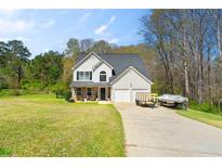 Charming two-story home featuring a well-maintained lawn and attached two car garage at 235 Hastings Ct, Mcdonough, GA 30252