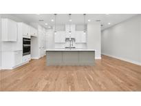 Bright kitchen with stainless steel appliances, white cabinets and a large gray kitchen island at 2540 Silver Star Ne Dr, Marietta, GA 30066