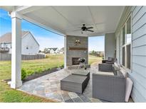This beautiful outdoor living space features a stone fireplace and plenty of room to relax and enjoy the backyard at 95 Summerlyn Dr, Hiram, GA 30141