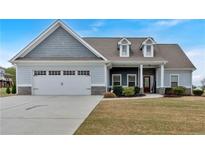 Charming single-Gathering home featuring a two-car garage, manicured lawn, and dormer windows at 95 Summerlyn Dr, Hiram, GA 30141