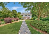 Charming two-story home with manicured front yard and stone pathway leading to the front entrance at 235 The Prado Nw, Atlanta, GA 30309