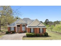 Charming two-story brick home with manicured lawn and mature trees, offering classic curb appeal at 2503 Westchester Se Way, Conyers, GA 30013