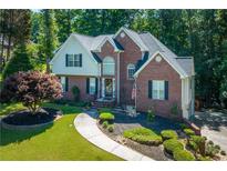 Beautiful two-story brick home with a well-manicured front yard and inviting walkway at 1107 Fieldstone Dr, Canton, GA 30114