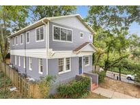 Charming two-story home featuring a mix of siding and brick with a well-maintained front yard at 811 Ponce De Leon Ne Pl, Atlanta, GA 30306