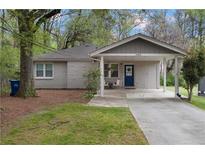Charming single-story home with a covered carport and well-maintained front lawn at 1963 Main Nw St, Atlanta, GA 30318