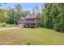 Charming home featuring a lush green lawn and a welcoming front porch perfect for relaxing outdoors at 4558 Dorsett Shoals Ct, Douglasville, GA 30135